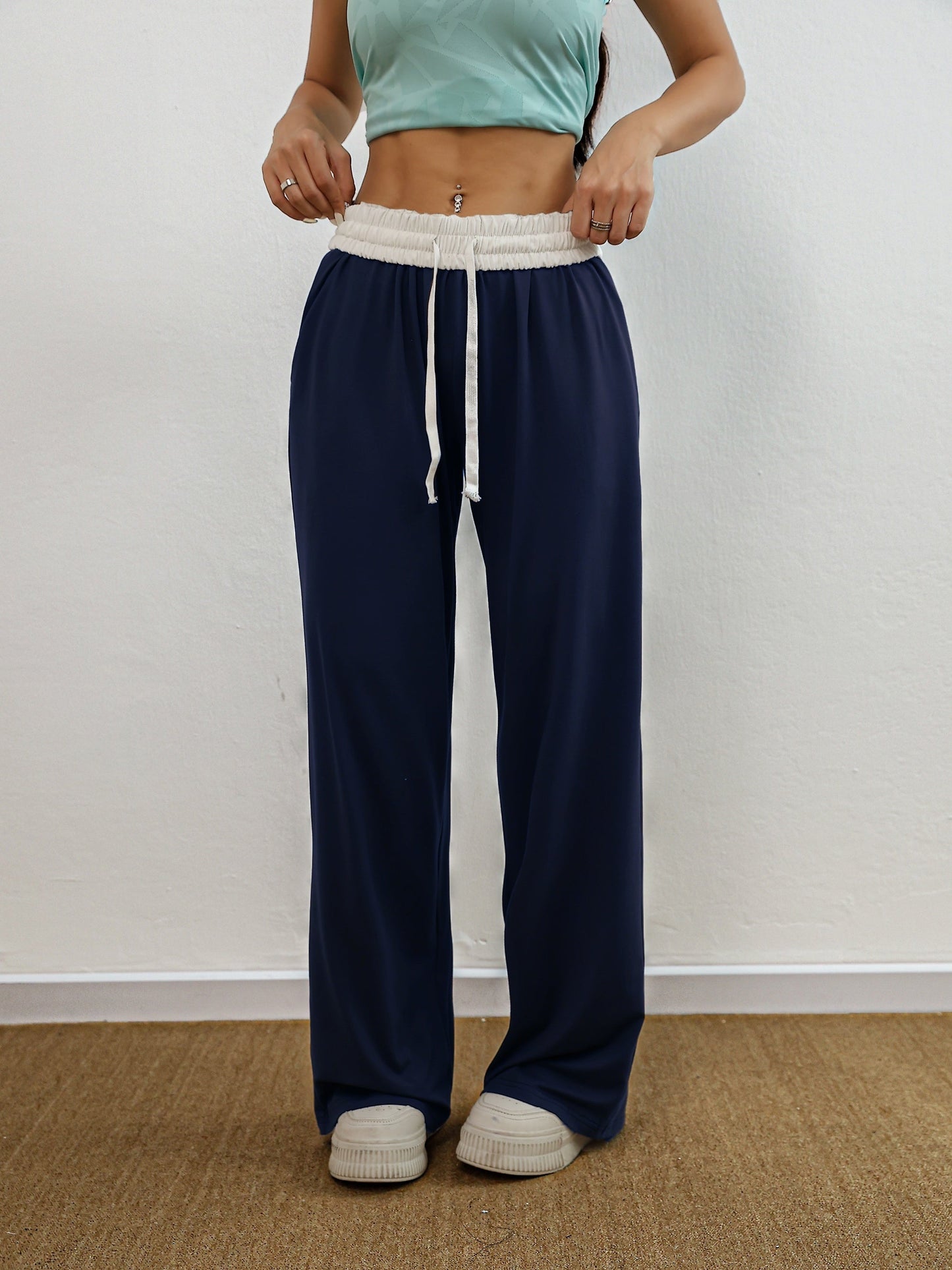 Nina | Wysokie elastyczne spodnie treningowe z kolorowymi blokami i kieszeniami